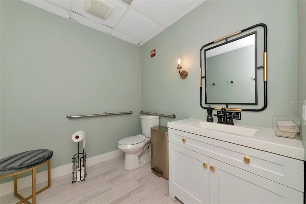 1345 2nd Street Sarasota, FL 34236 - Photo 35 of 98 a bathroom with a toilet sink and mirror