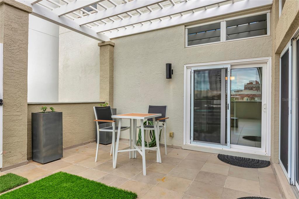 1345 2nd Street Sarasota, FL 34236 - Photo 76 of 98 a patio with a table and chairs and potted plants