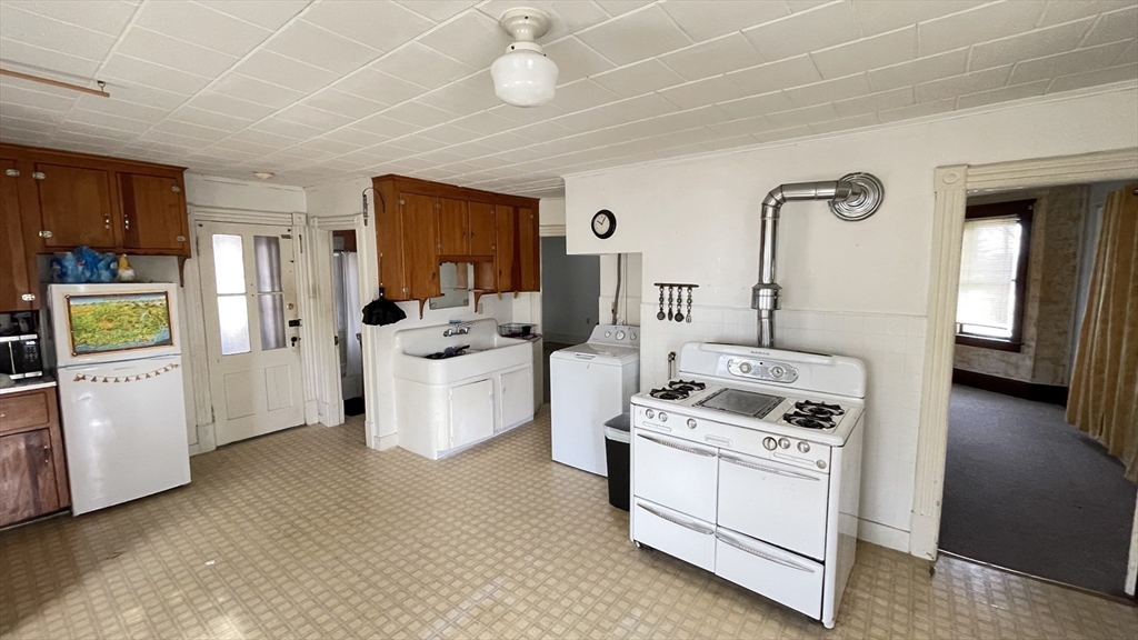 755 Grattan Street Chicopee, MA 01020 - Photo 24 of 39 a kitchen with a stove cabinets and wooden floor