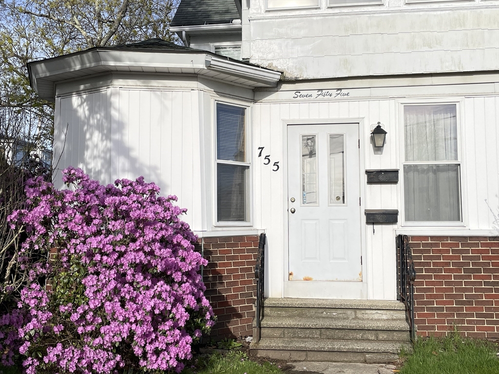 755 Grattan Street Chicopee, MA 01020 - Photo 3 of 39 a front view of a house with a garage