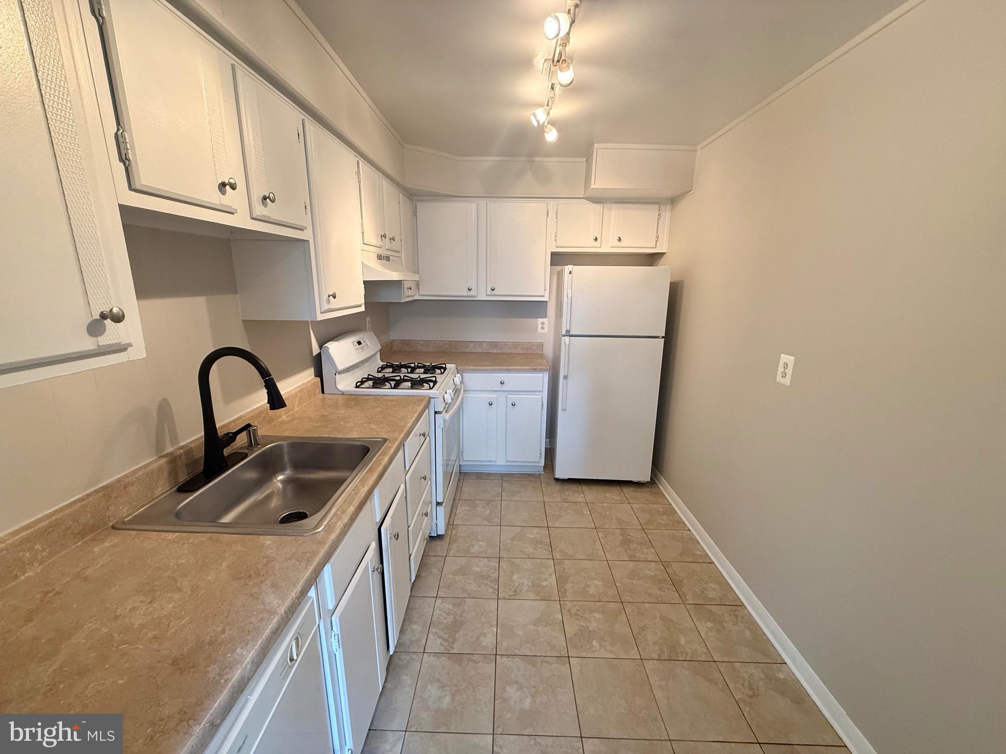 5111 8th Road South, Unit 203 Arlington, VA 22204 - Photo 12 of 31 a kitchen with a sink a refrigerator and cabinets