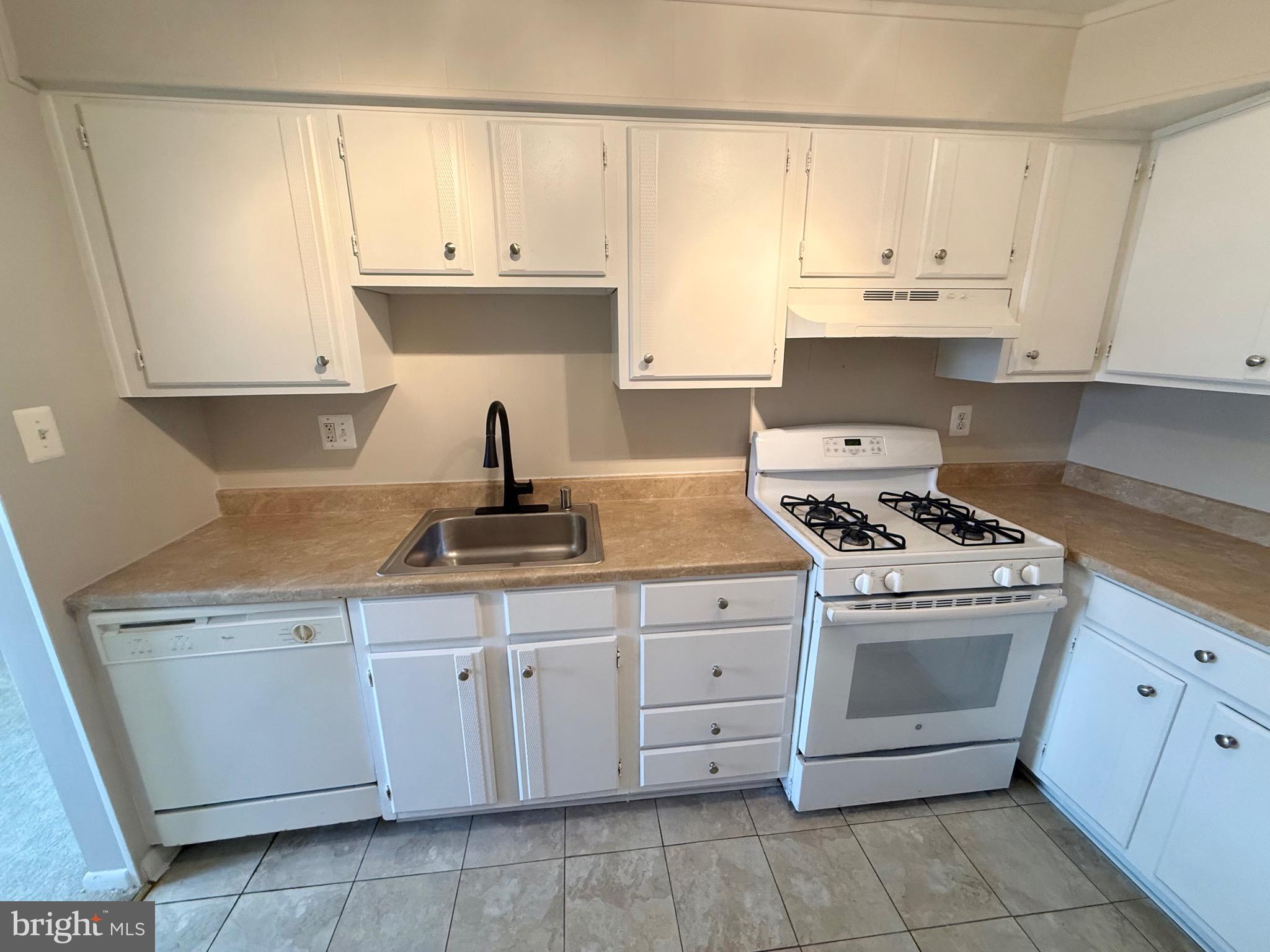 5111 8th Road South, Unit 203 Arlington, VA 22204 - Photo 13 of 31 a kitchen with granite countertop white cabinets and white appliances