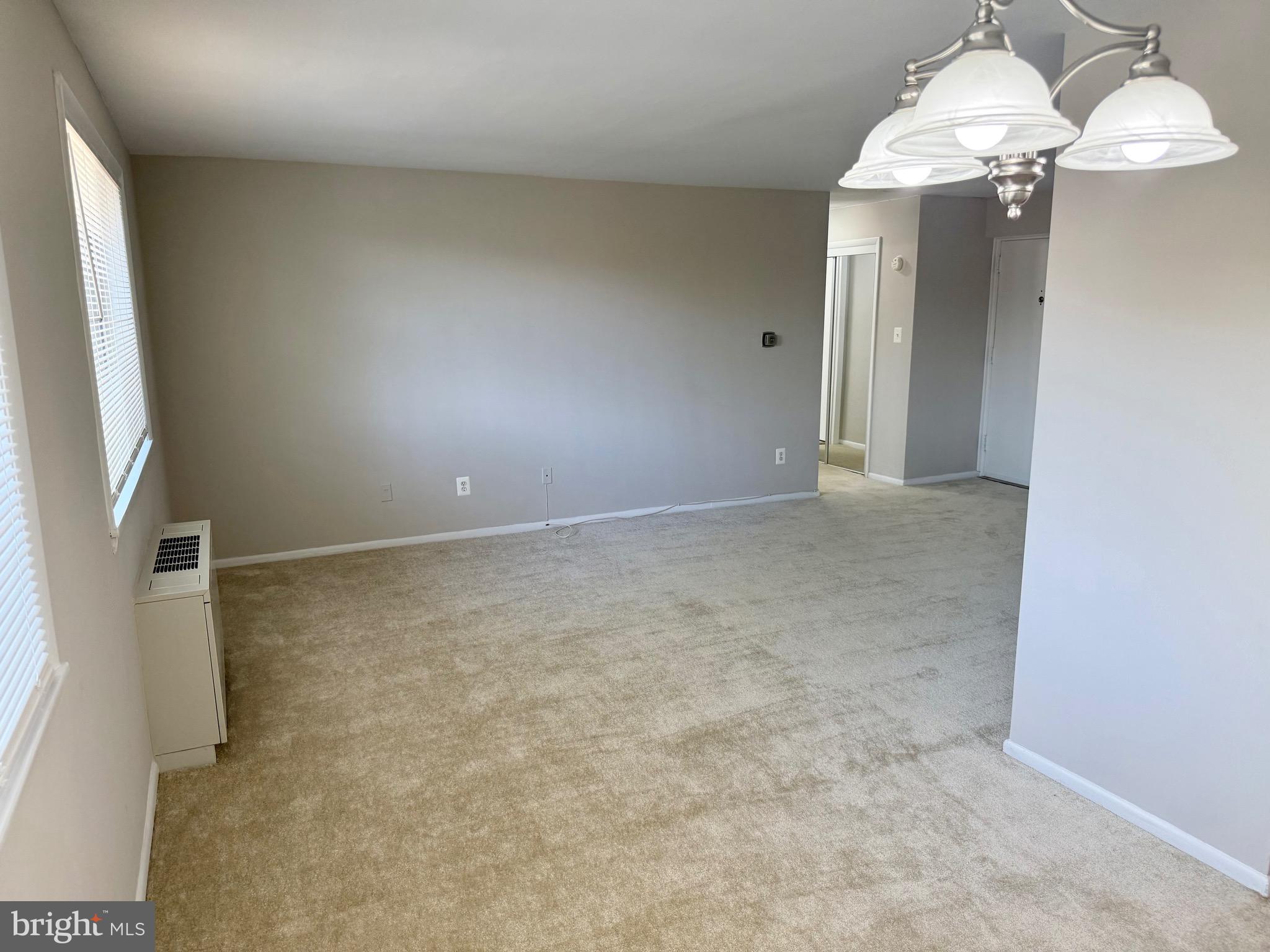 5111 8th Road South, Unit 203 Arlington, VA 22204 - Photo 14 of 31 en empty room with windows and chandelier fan