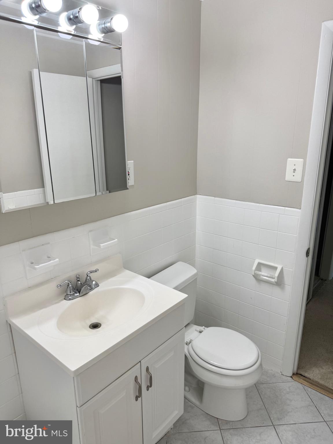 5111 8th Road South, Unit 203 Arlington, VA 22204 - Photo 24 of 31 a bathroom with a sink a toilet and a mirror