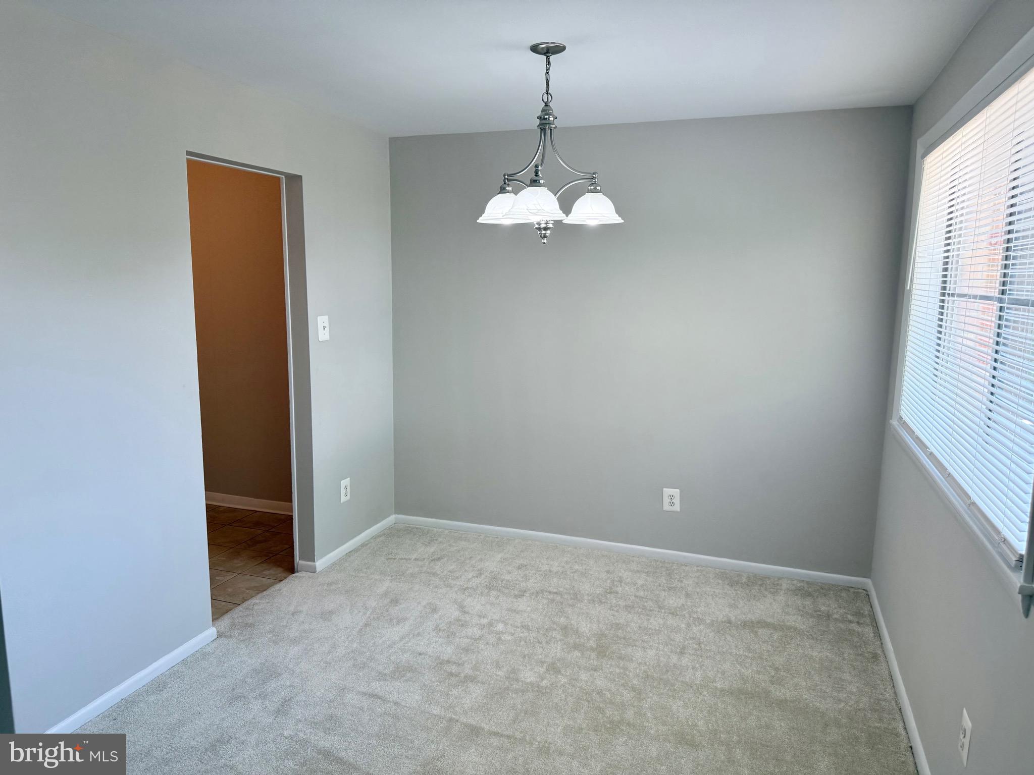 5111 8th Road South, Unit 203 Arlington, VA 22204 - Photo 9 of 31 an empty room with chandelier fan and windows