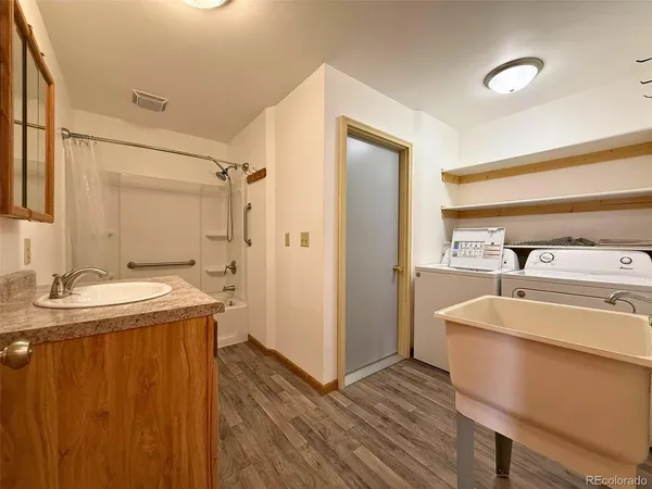 a bathroom with a granite countertop sink toilet and shower