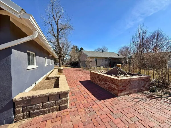 a view of a house with a yard covered in snow