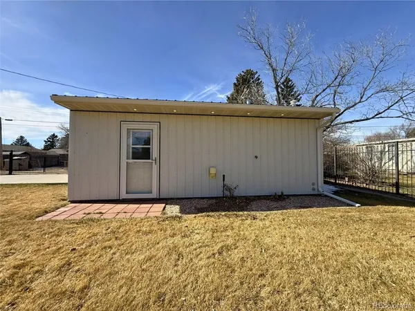 a view of a front door and a yard
