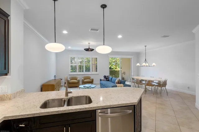 a kitchen with a dining table chairs and white cabinets
