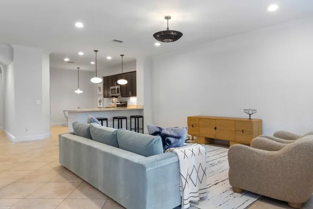 a living room with furniture and a ceiling fan
