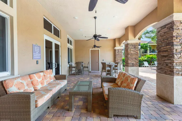 a view of a patio with a dining table and chairs with wooden floor