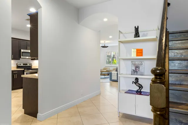 a kitchen with stainless steel appliances kitchen island granite countertop a refrigerator and a stove top oven