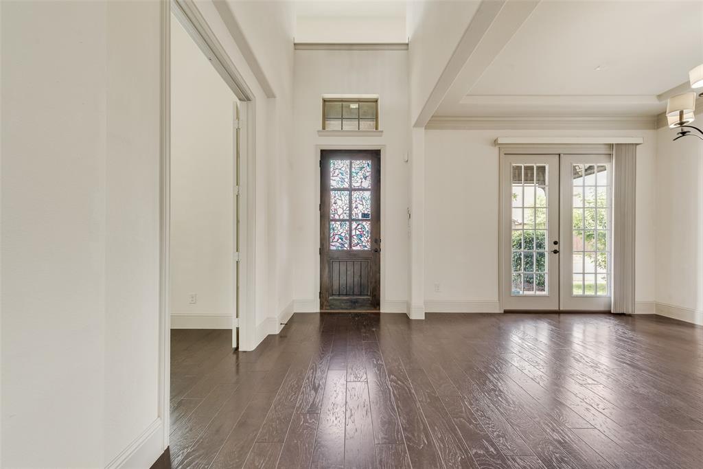 2021 Calisto Way Allen, TX 75013 - Photo 8 of 34 Spacious room featuring dark wood-finish flooring, white walls, and high ceilings with decorative beams