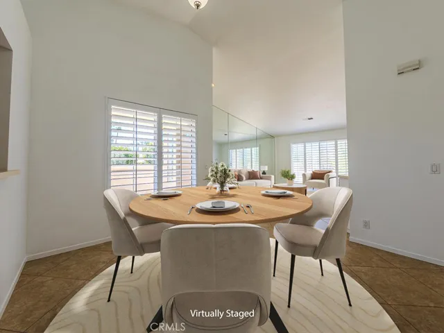 a dining room with furniture a rug and wooden floor