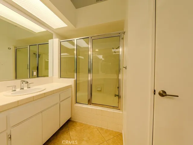 a bathroom with a shower and a sink