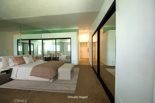 a large bedroom with a large bed and a large window