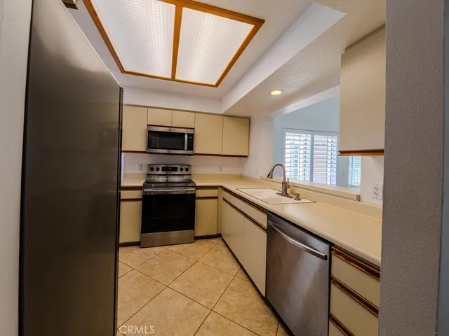 a kitchen with stainless steel appliances granite countertop a sink and a stove