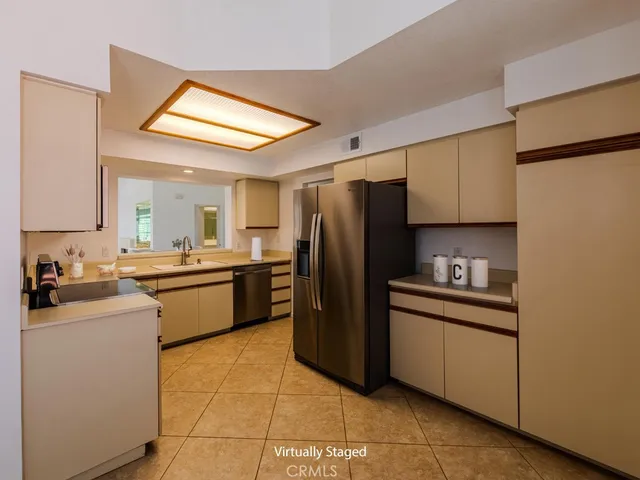 a kitchen with a sink appliances and cabinets