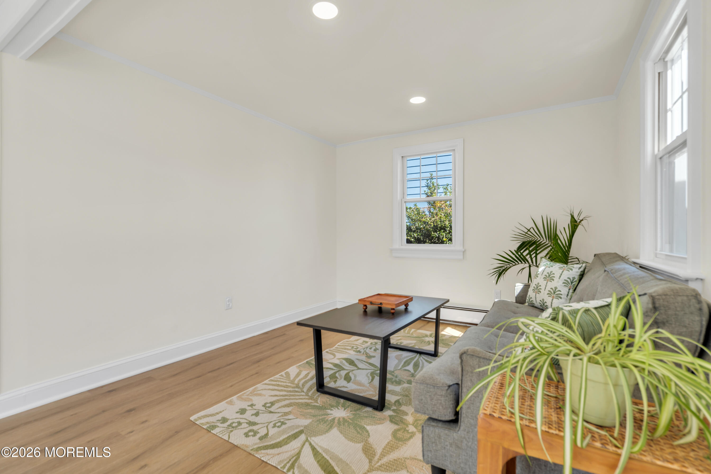 137 Inskip Avenue Ocean Grove, NJ 07756 - Photo 17 of 36 a living room with a wooden floor and a potted plant