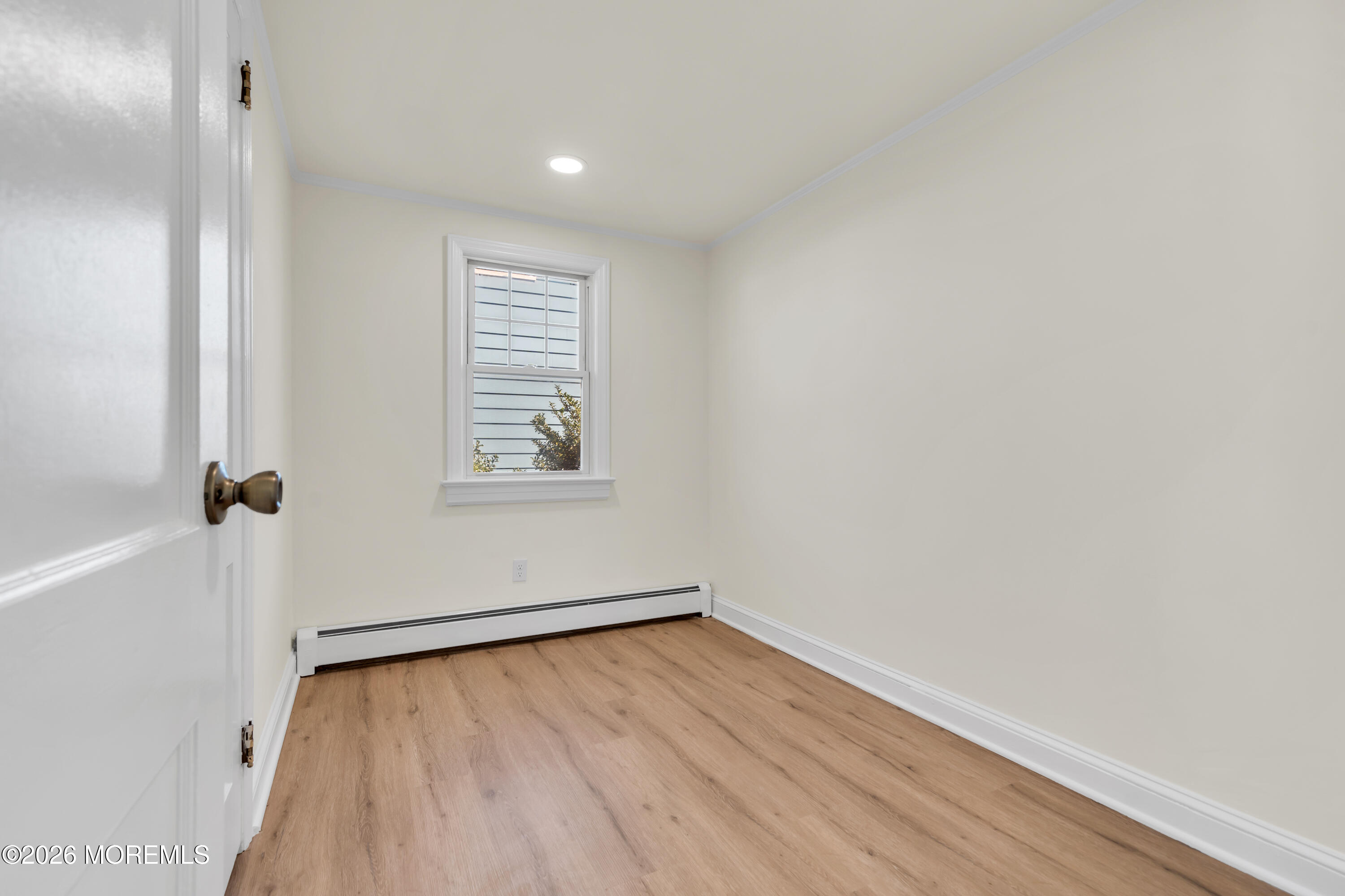 137 Inskip Avenue Ocean Grove, NJ 07756 - Photo 20 of 36 a view of an empty room with wooden floor and a window