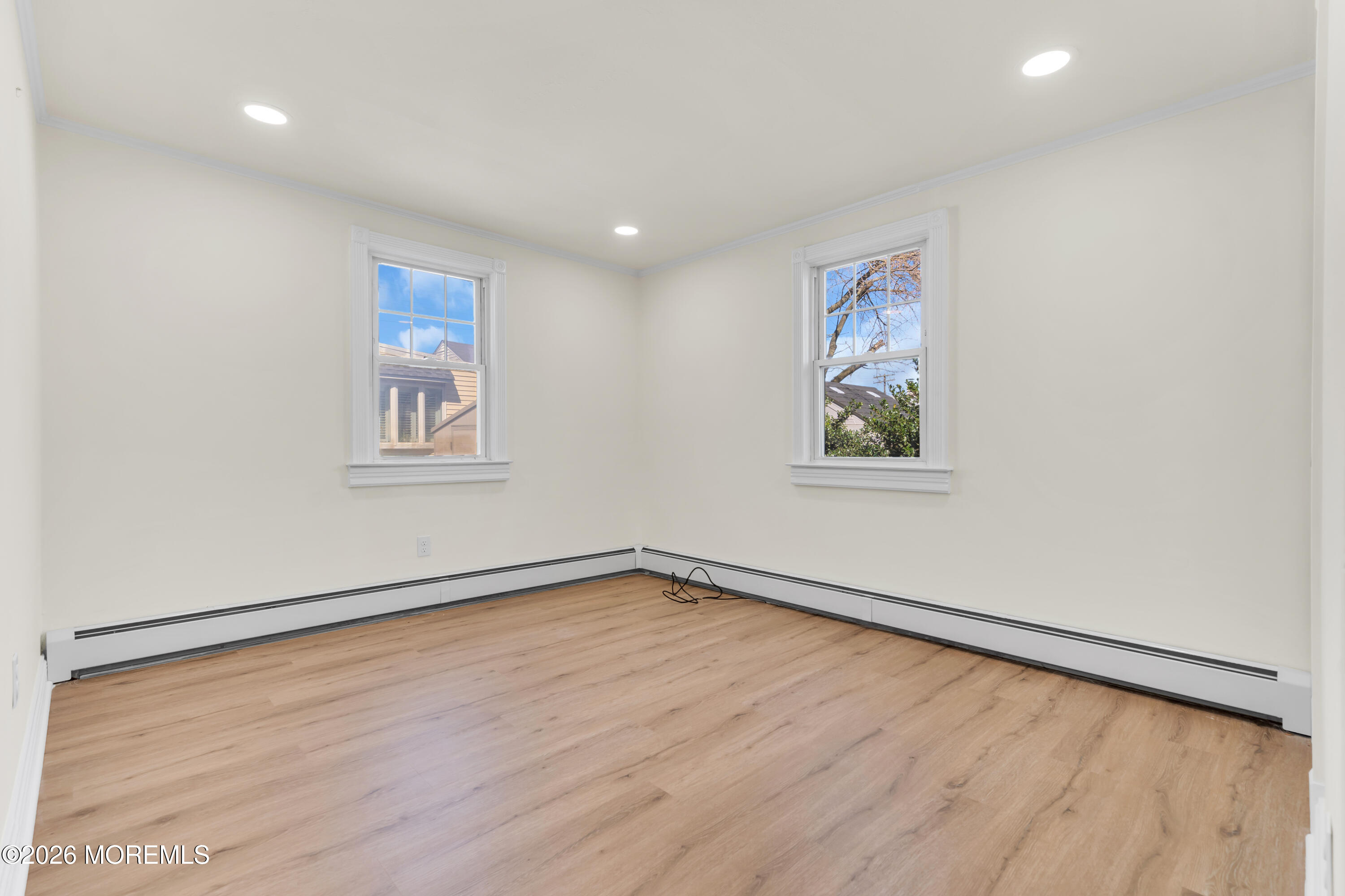 137 Inskip Avenue Ocean Grove, NJ 07756 - Photo 22 of 36 a view of an empty room with a window and wooden floor