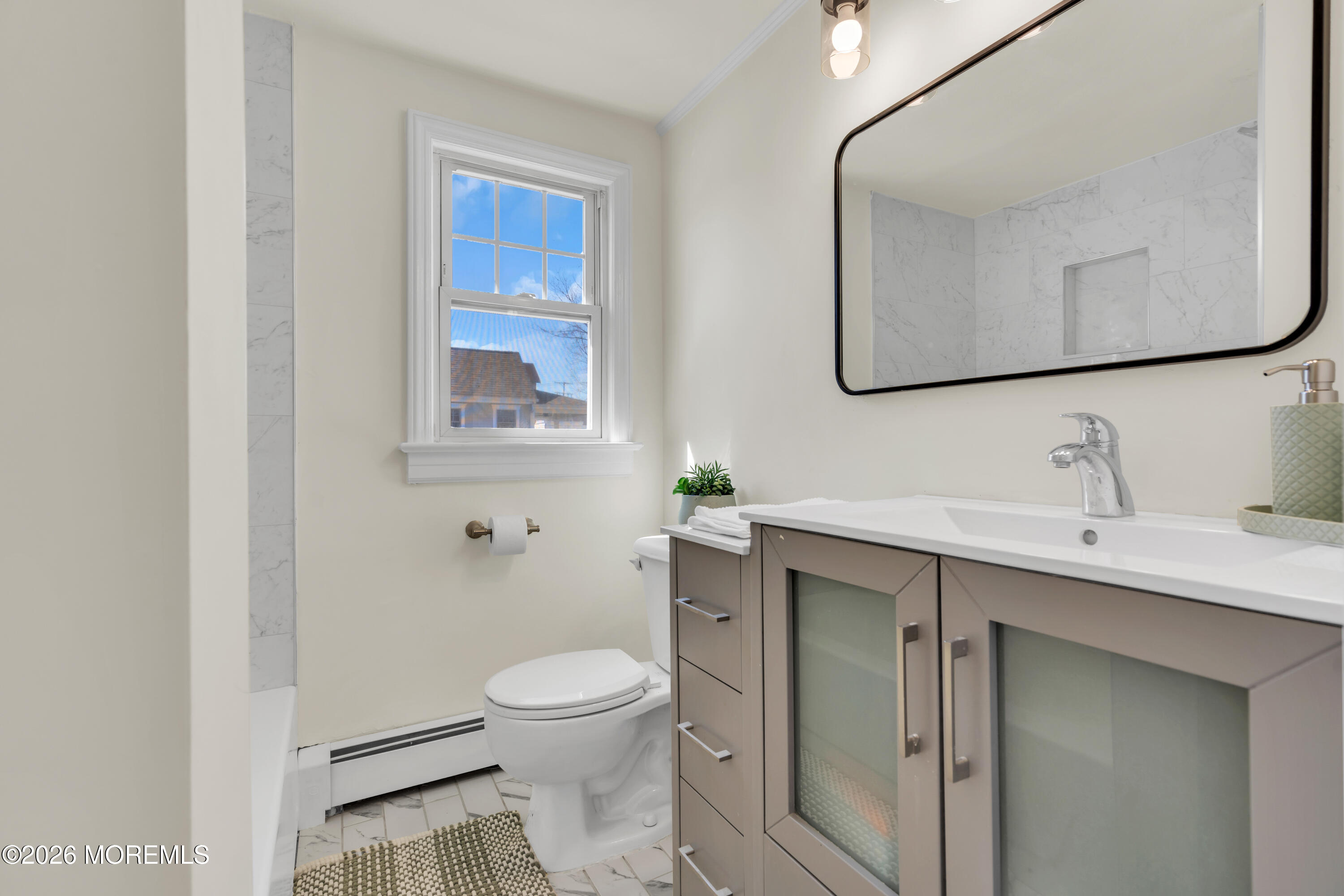 137 Inskip Avenue Ocean Grove, NJ 07756 - Photo 27 of 36 a bathroom with a toilet a sink and mirror
