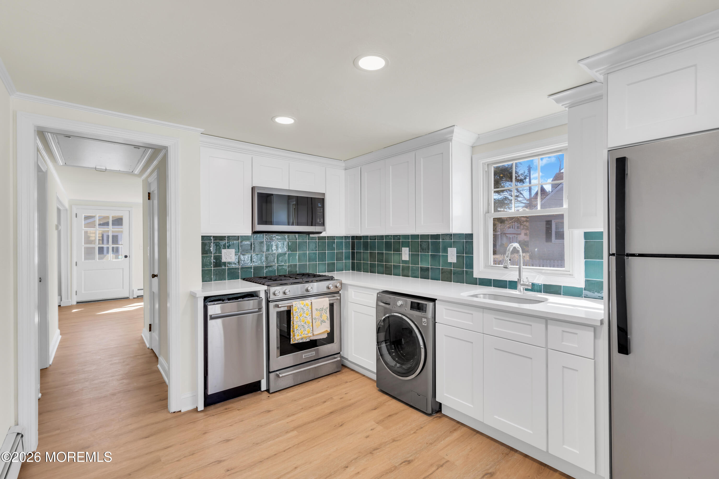 137 Inskip Avenue Ocean Grove, NJ 07756 - Photo 32 of 36 a kitchen with a stove top oven sink and refrigerator