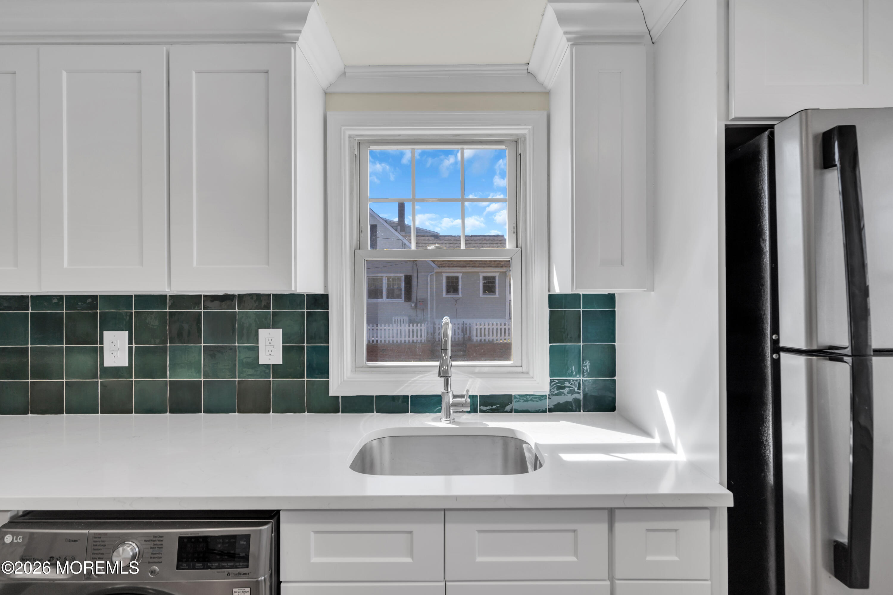 137 Inskip Avenue Ocean Grove, NJ 07756 - Photo 34 of 36 a kitchen with a sink and a refrigerator