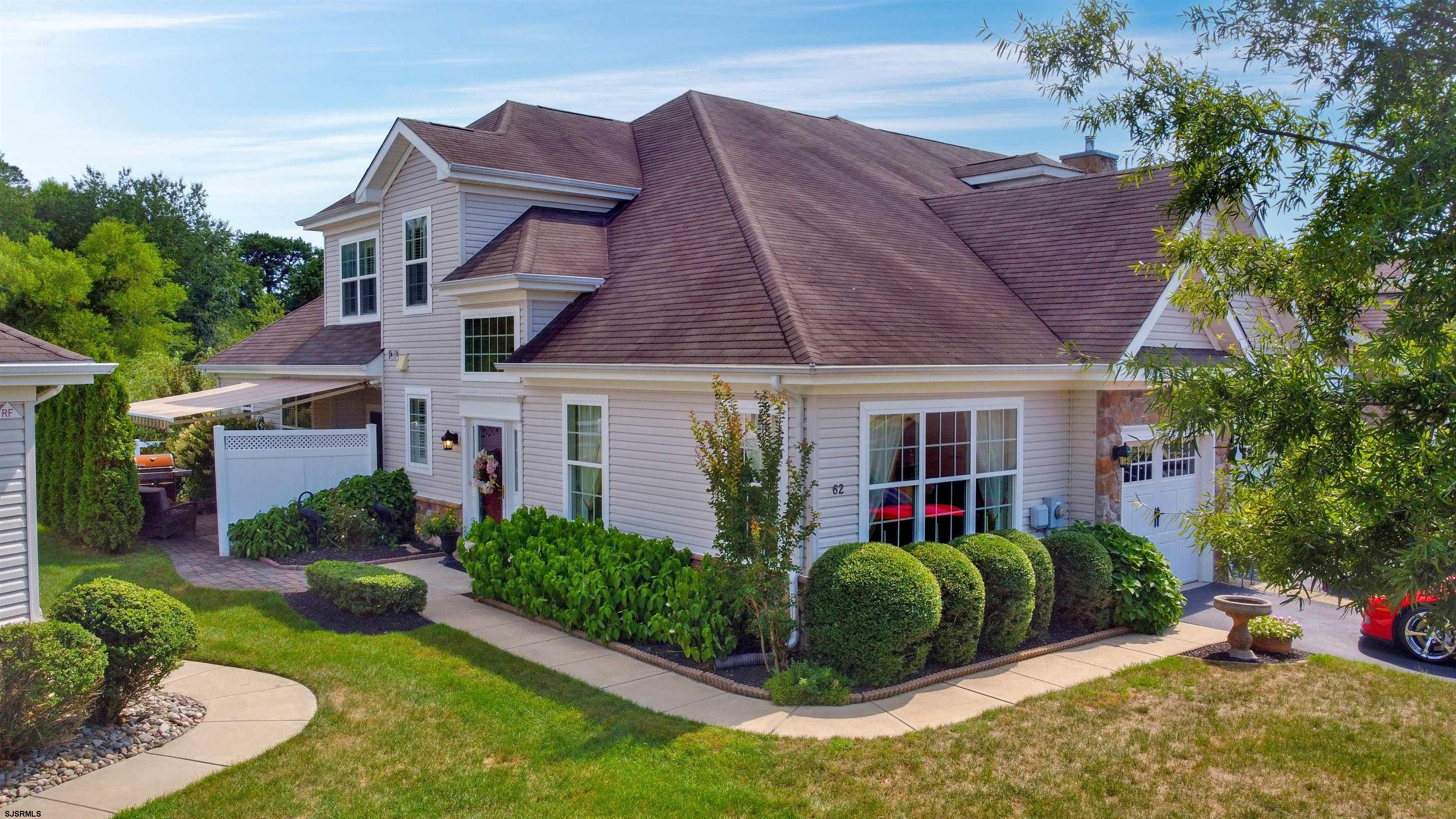 a view of a house with a small yard and plants