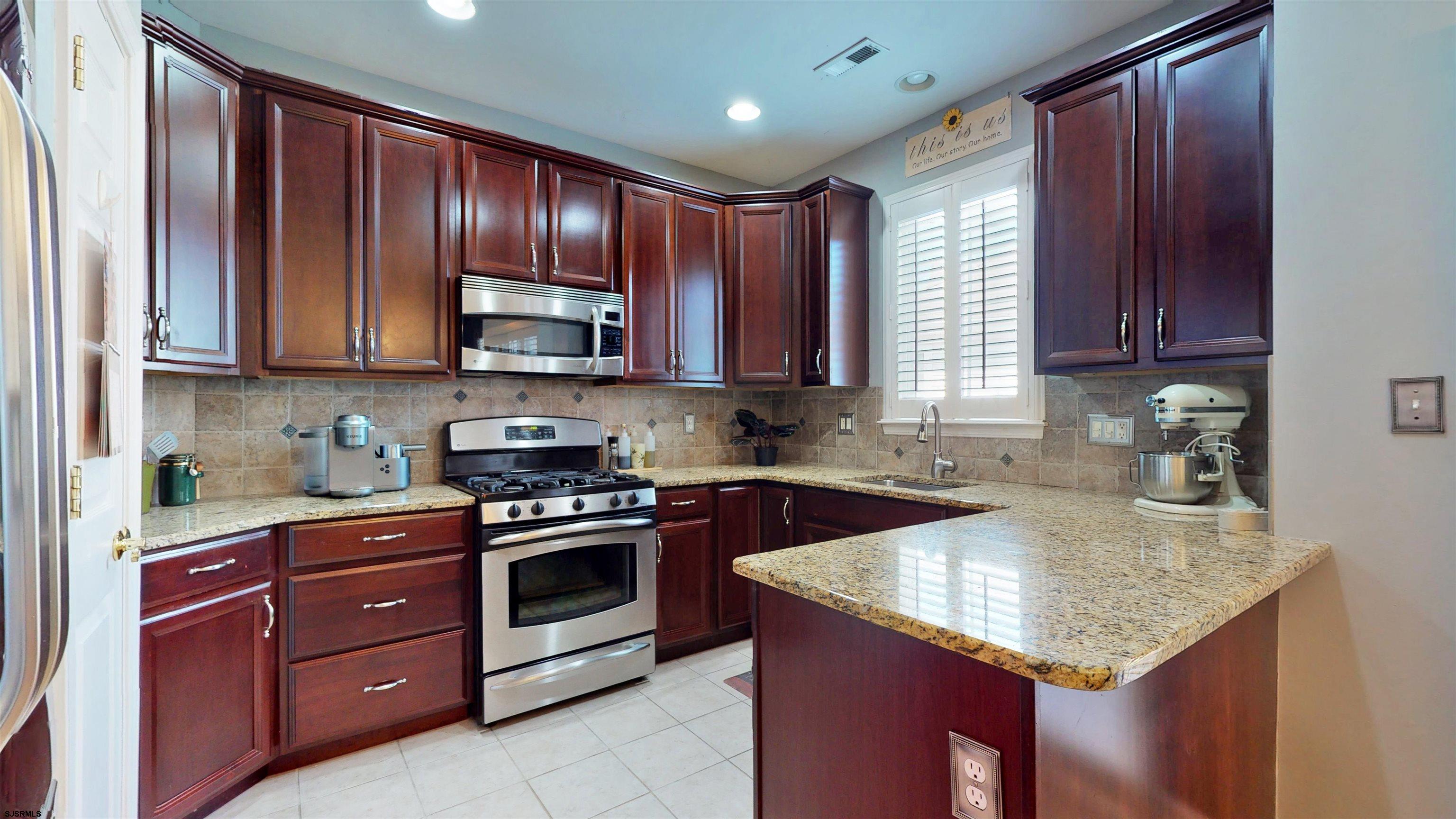 62 Ables Run Drive Absecon, NJ 08201 - Photo 12 of 38 a kitchen with a sink stove top oven and cabinets