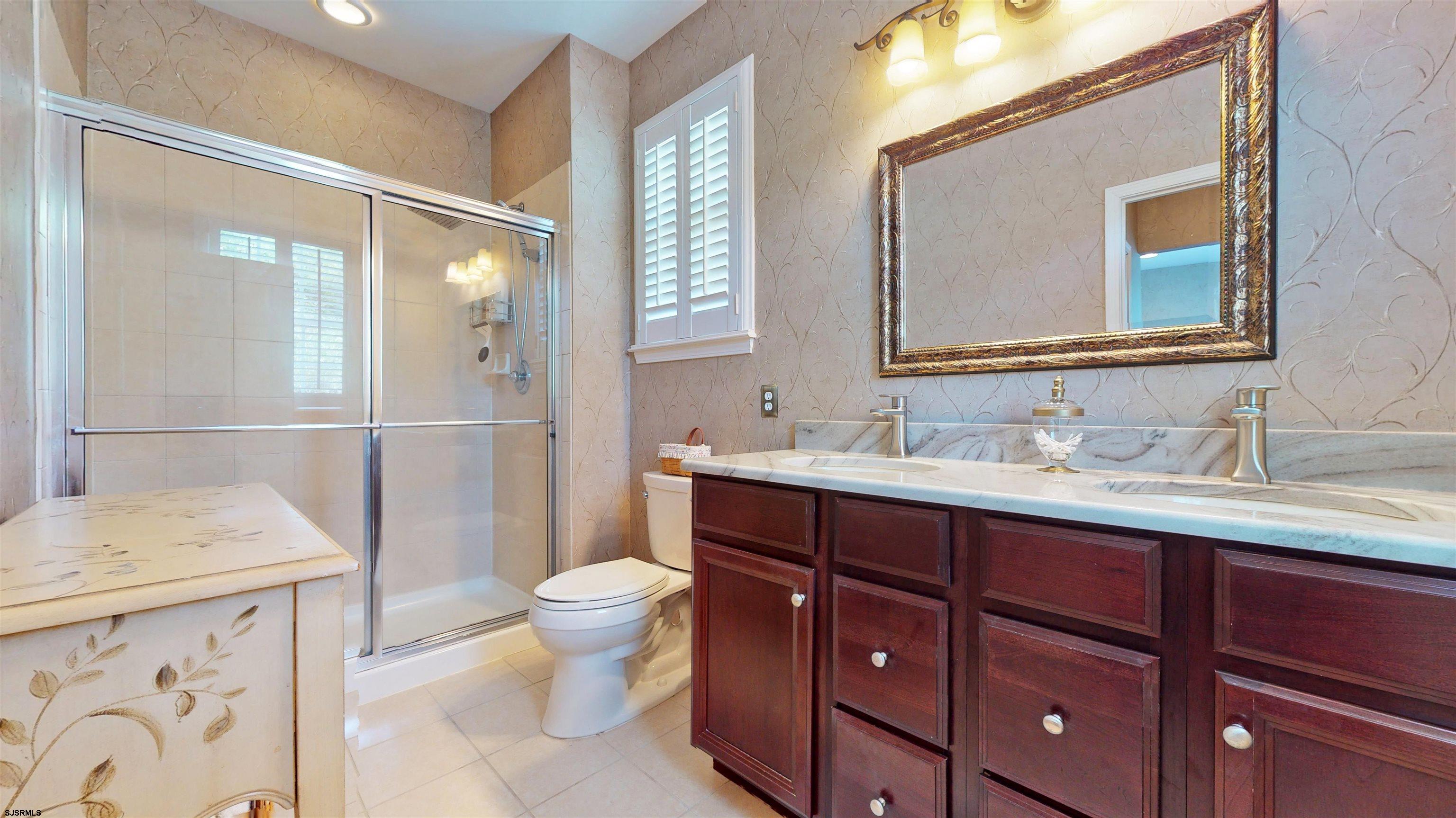 62 Ables Run Drive Absecon, NJ 08201 - Photo 19 of 38 a bathroom with a sink a toilet and a mirror