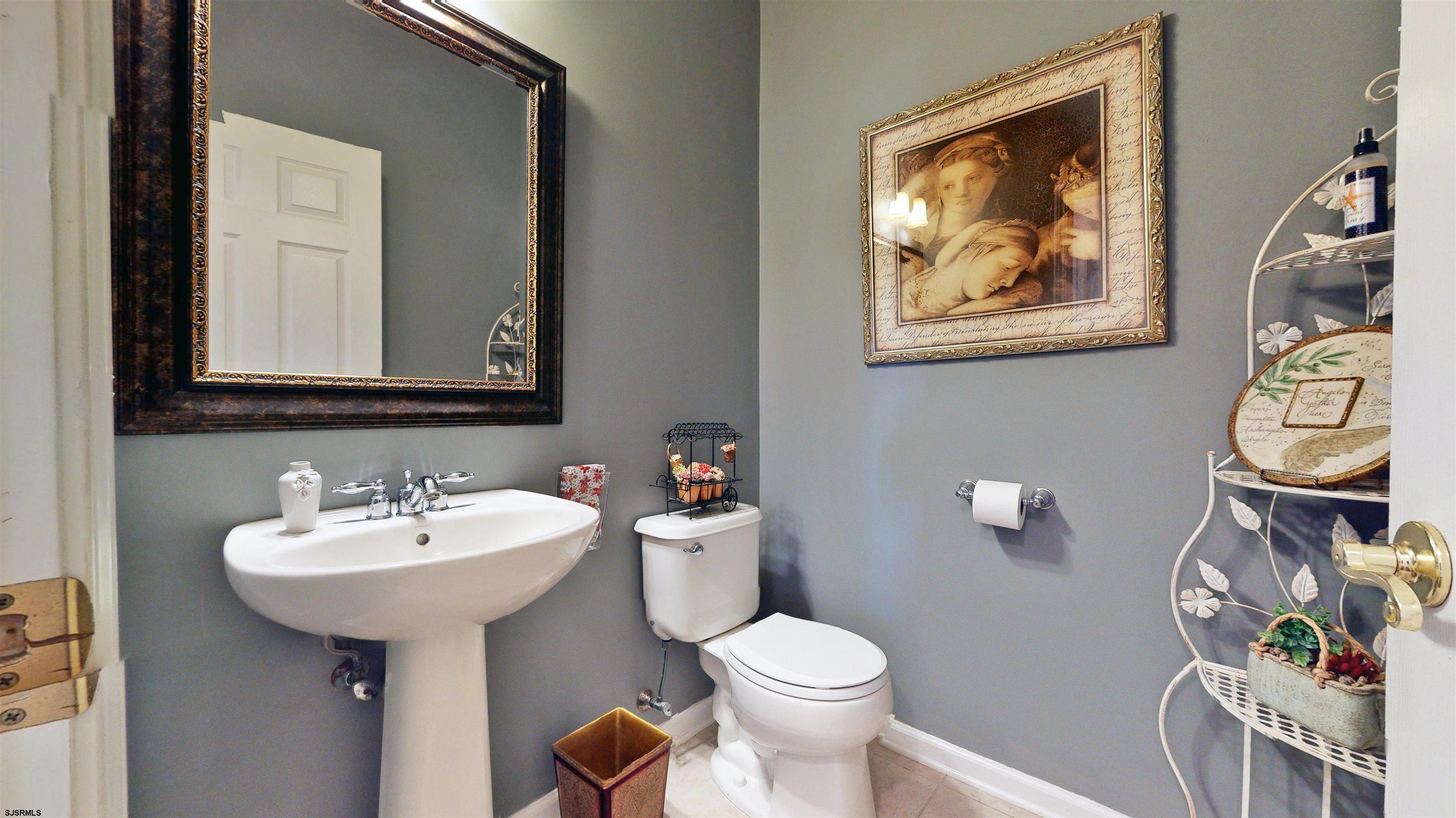 62 Ables Run Drive Absecon, NJ 08201 - Photo 22 of 38 a bathroom with a toilet a sink and mirror