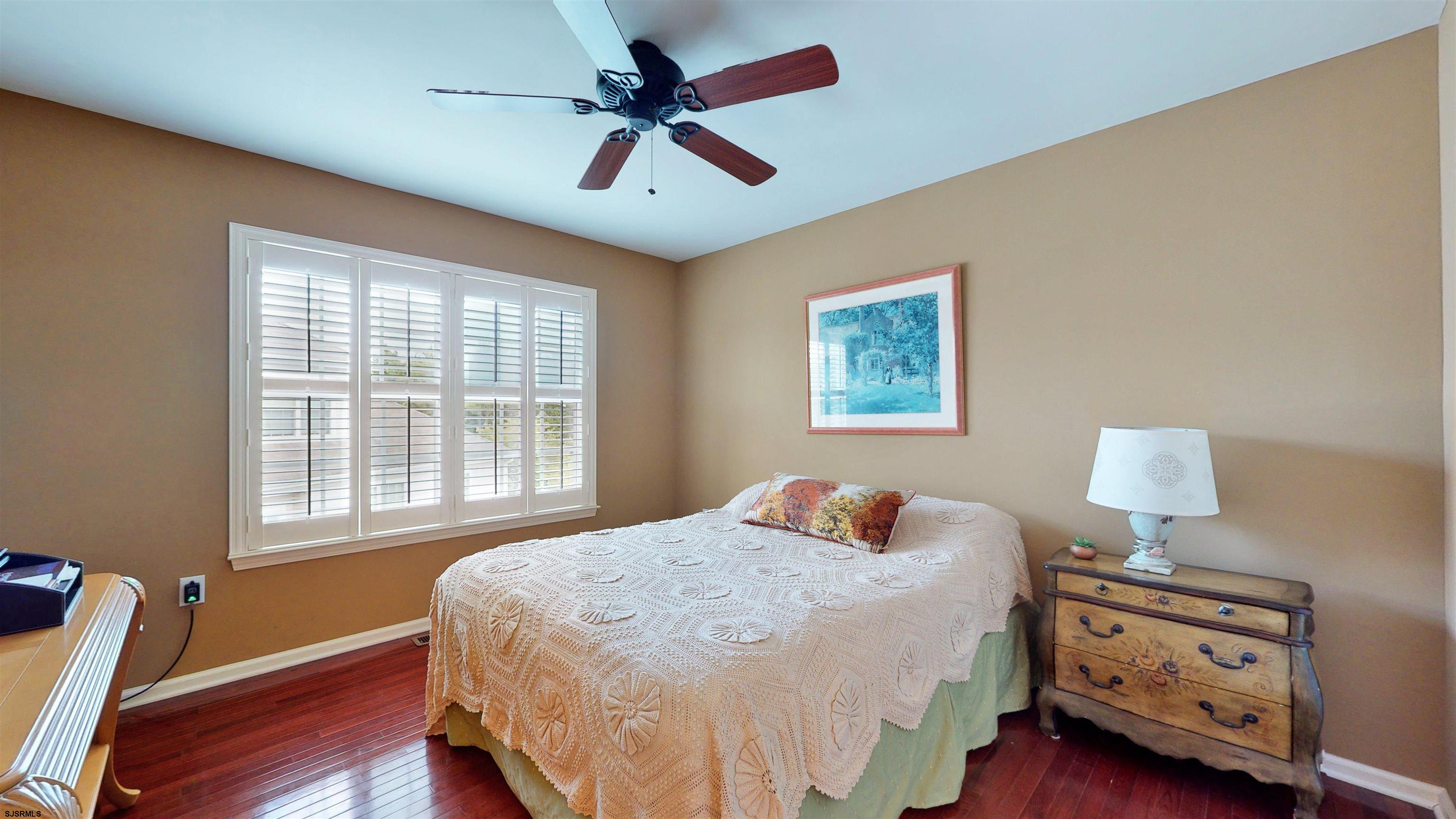 62 Ables Run Drive Absecon, NJ 08201 - Photo 27 of 38 a bedroom with a bed and a lamp on dresser