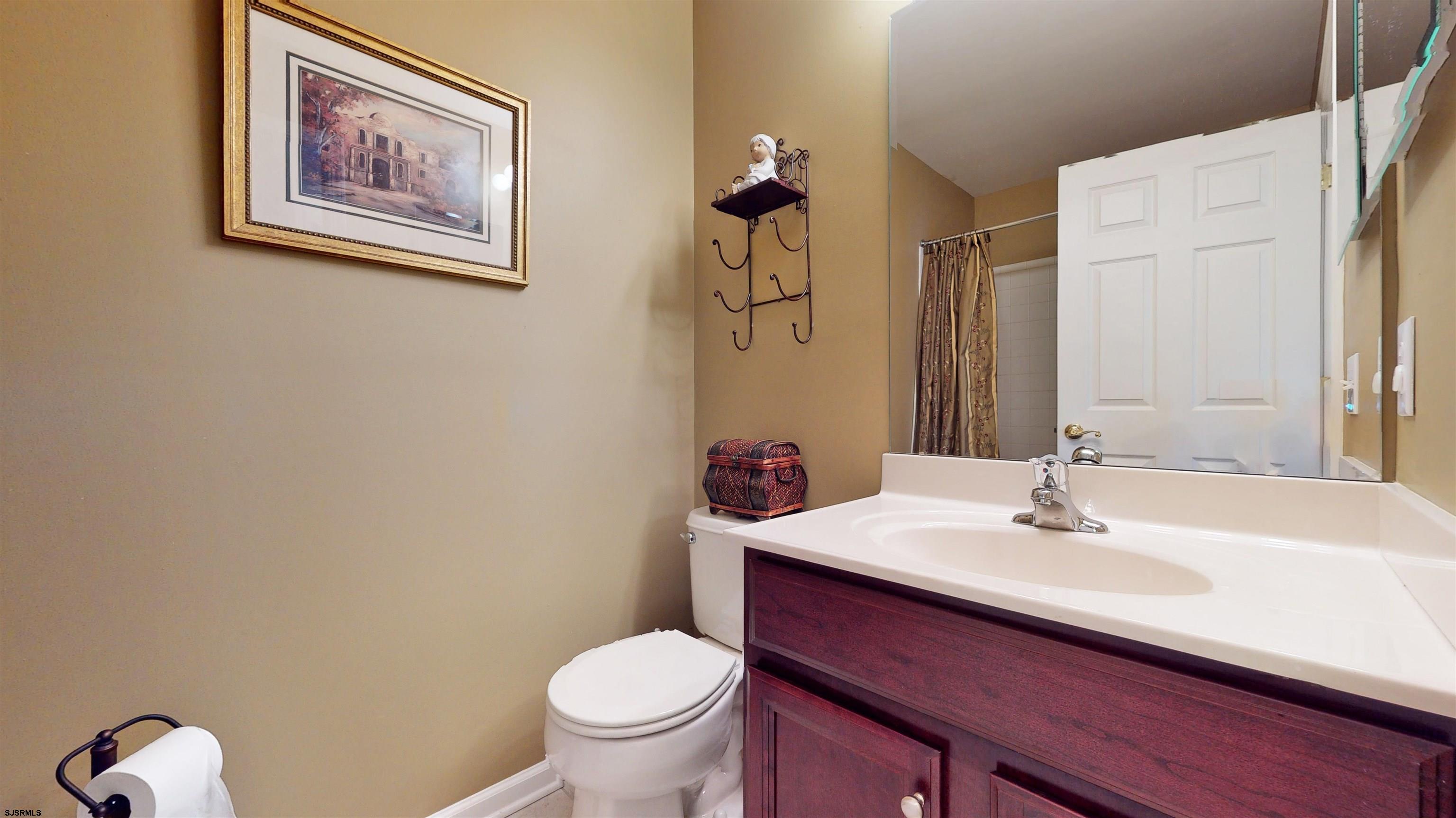 62 Ables Run Drive Absecon, NJ 08201 - Photo 28 of 38 a bathroom with a sink mirror and toilet