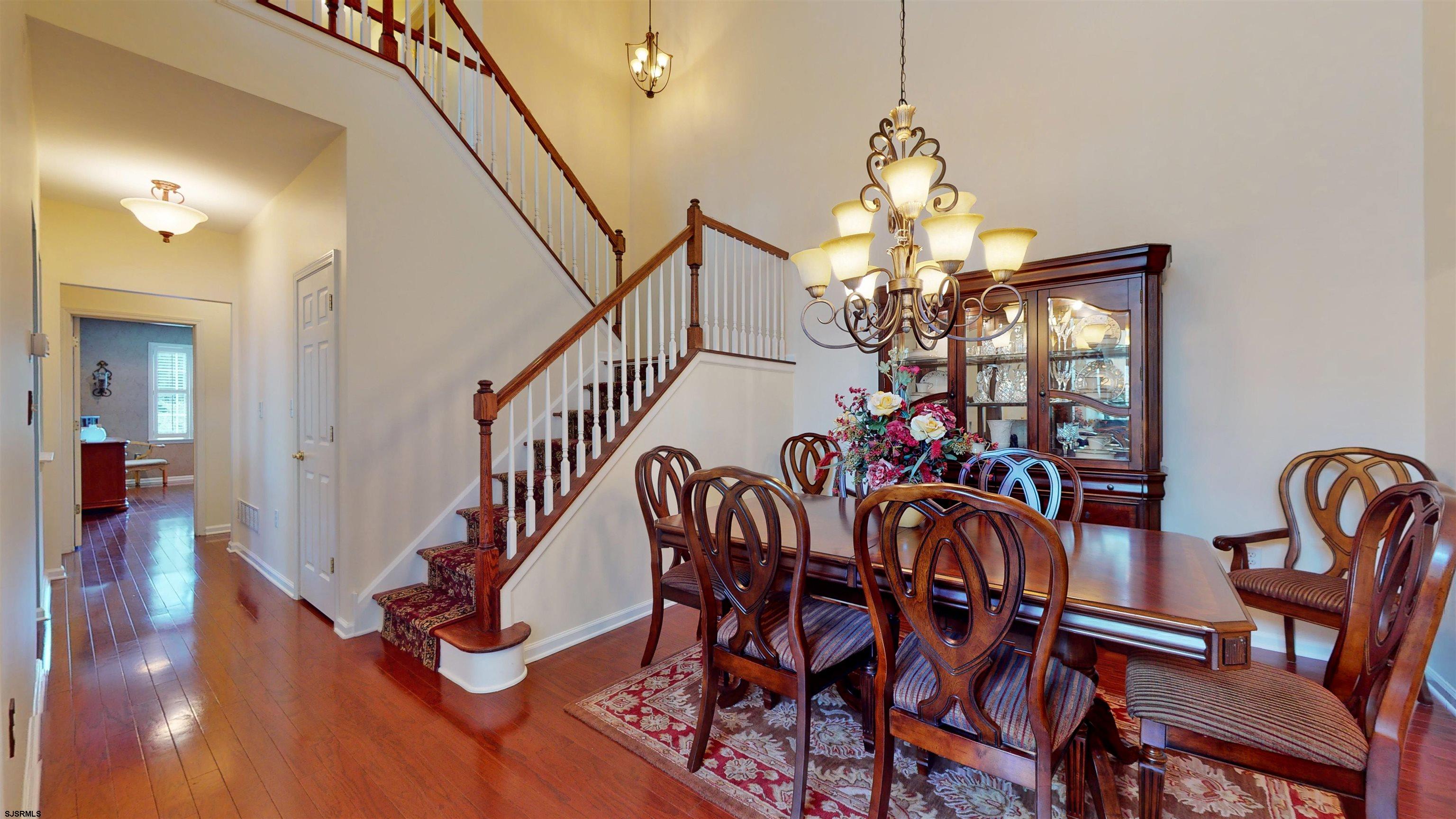 62 Ables Run Drive Absecon, NJ 08201 - Photo 8 of 38 a view of a dining room with furniture wooden floor and chandelier