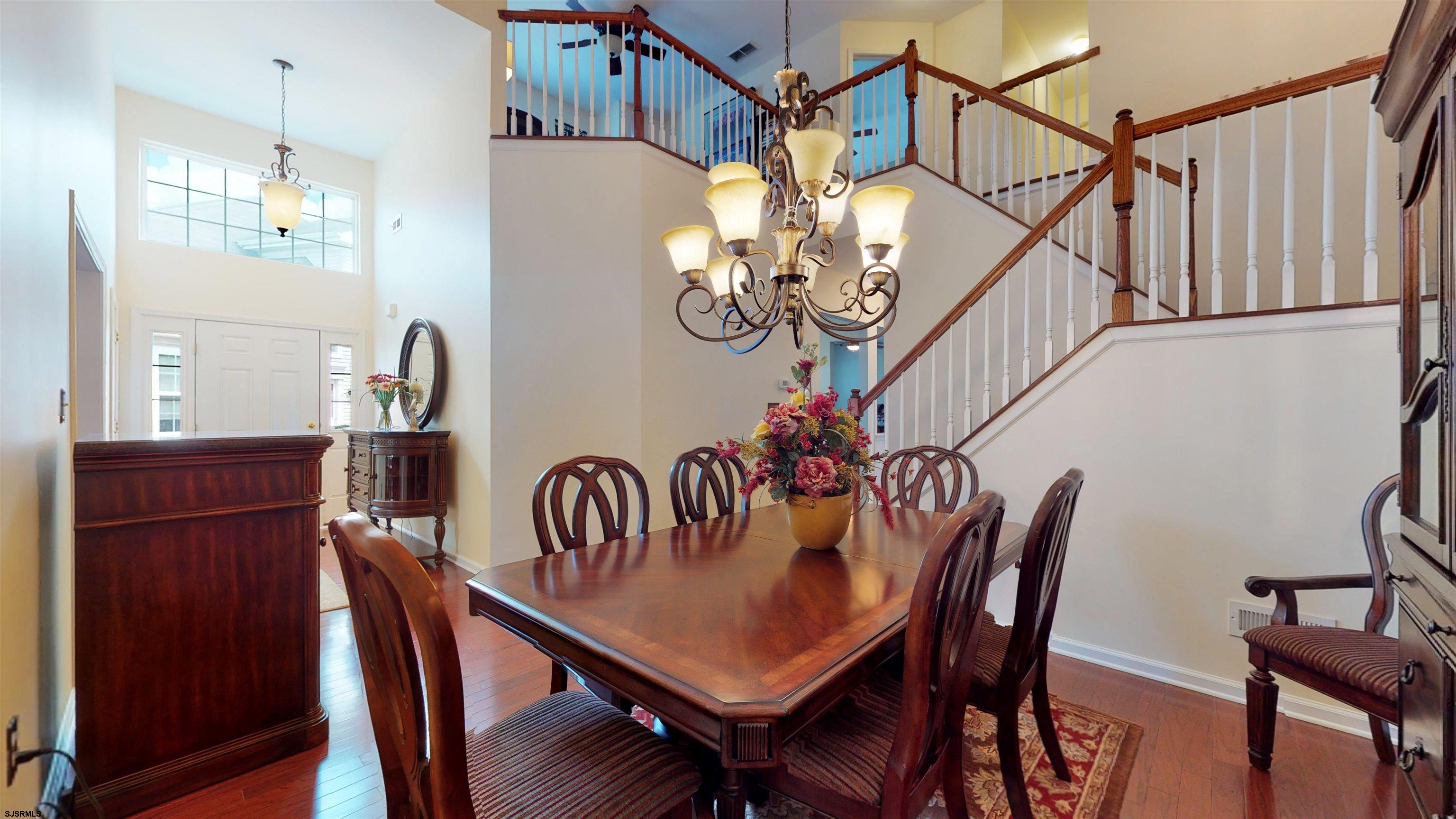 62 Ables Run Drive Absecon, NJ 08201 - Photo 9 of 38 a dining room with furniture a chandelier and wooden floor