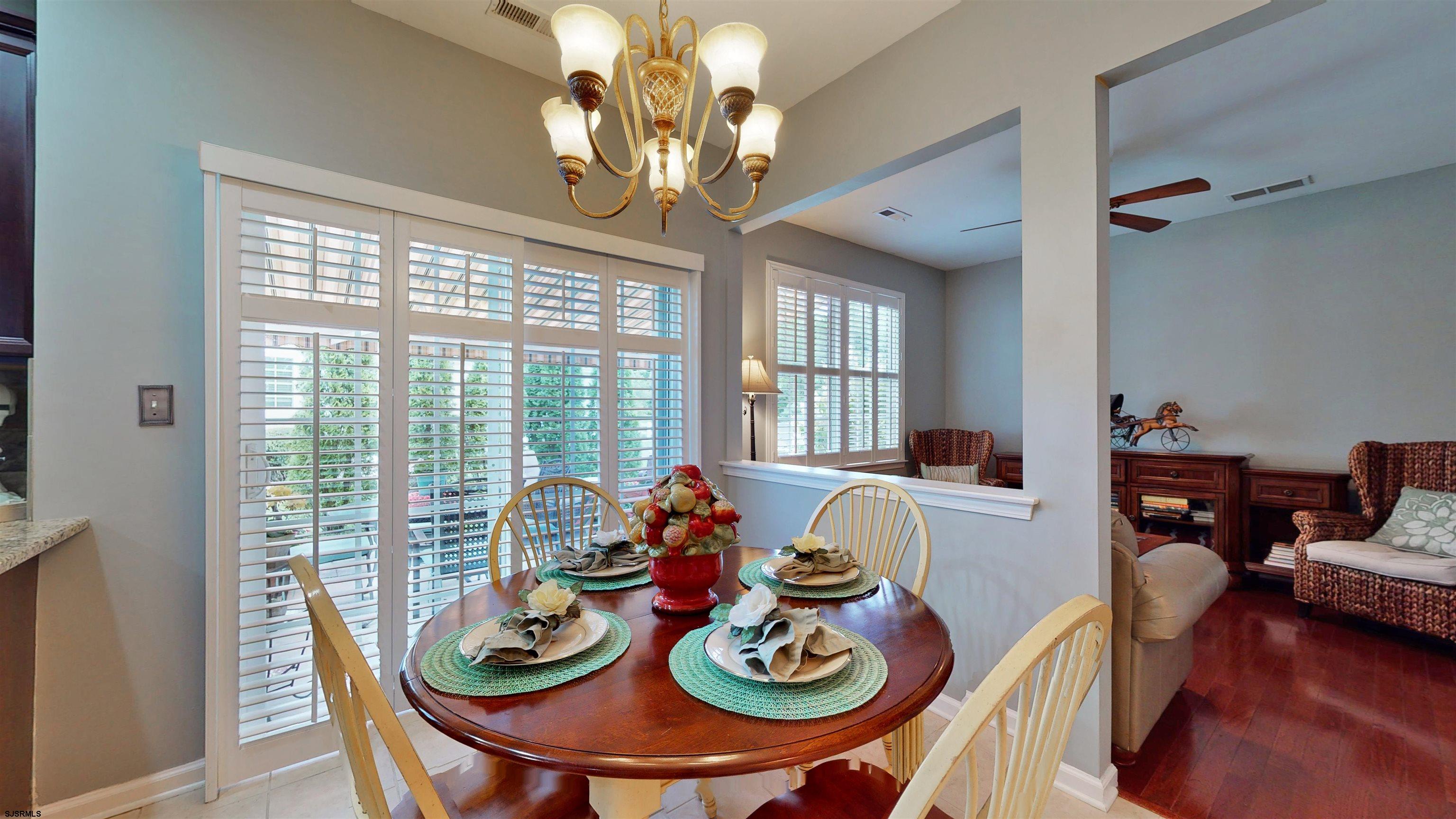 62 Ables Run Drive Absecon, NJ 08201 - Photo 10 of 38 a view of a dining room with furniture a chandelier and windows