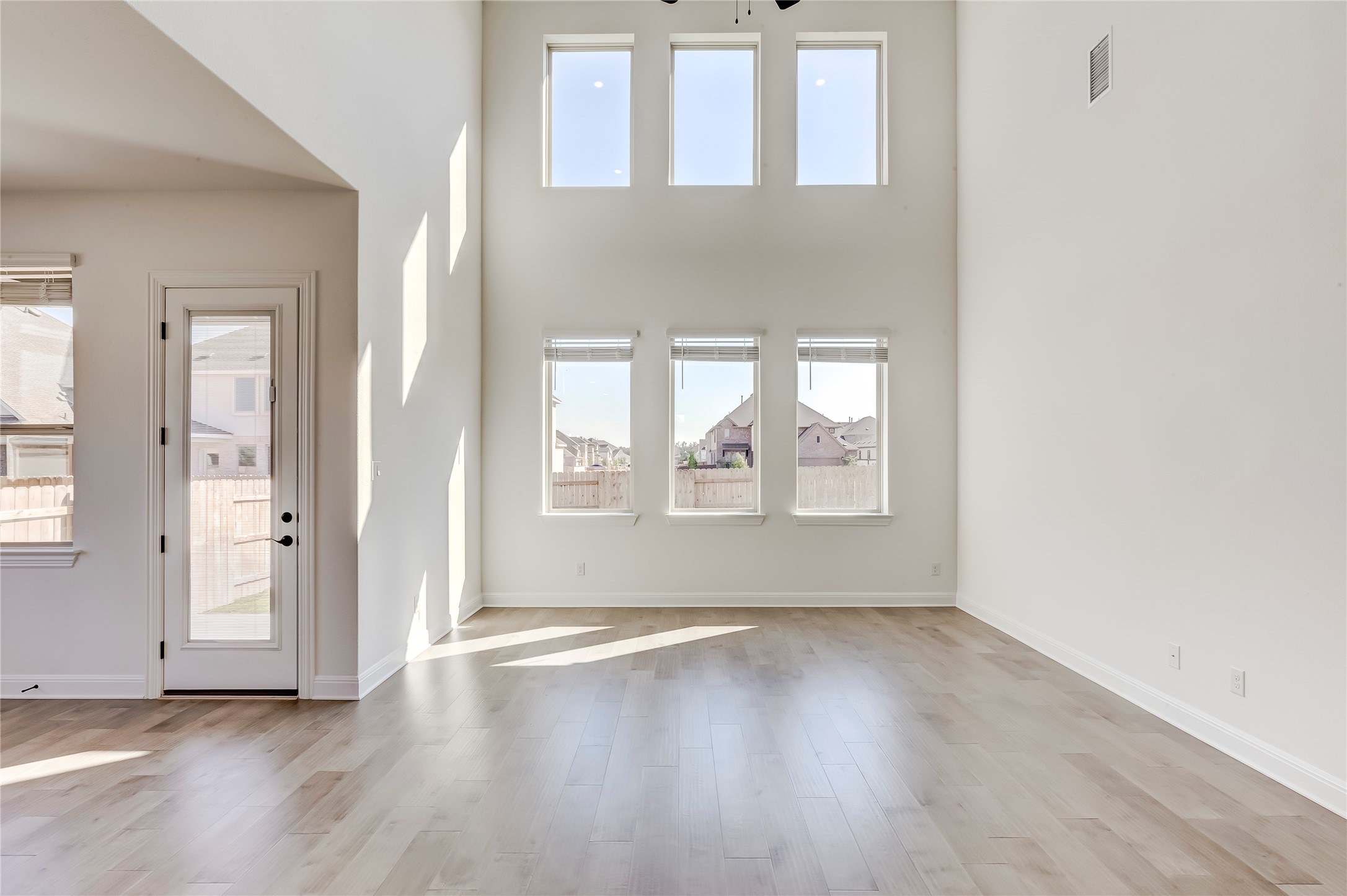 920 Old Gdn Road Leander, TX 78641 - Photo 6 of 39 Unfurnished living room featuring a towering ceiling and light wood-style floors