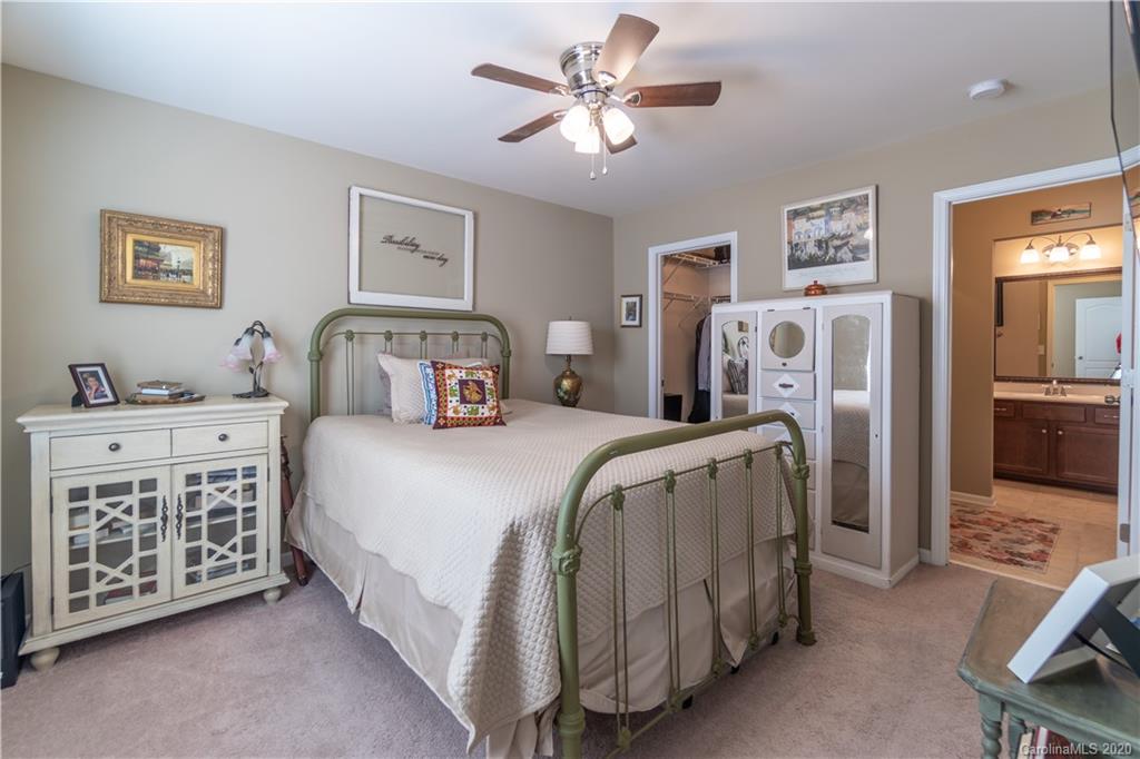 4051 Perth Road Indian Land, SC 29707 - Photo 23 of 31 a bedroom with a bed and a chandelier