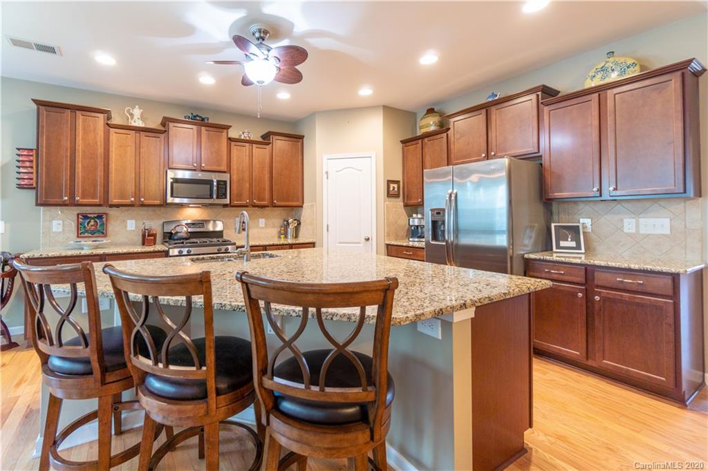 4051 Perth Road Indian Land, SC 29707 - Photo 6 of 31 a kitchen with kitchen island granite countertop wooden cabinets and stainless steel appliances