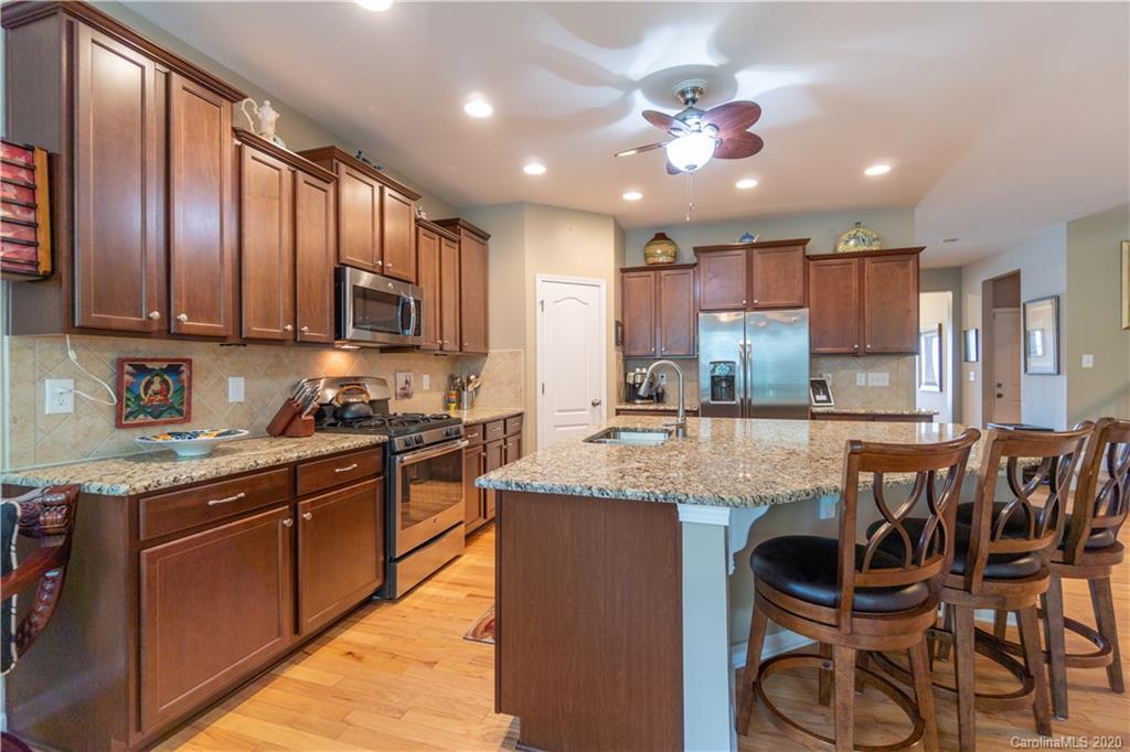 4051 Perth Road Indian Land, SC 29707 - Photo 7 of 31 a kitchen with granite countertop wooden cabinets and stainless steel appliances