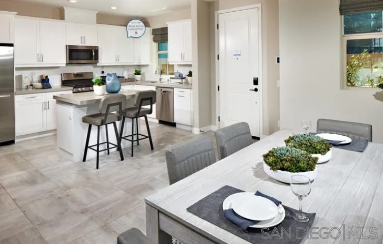 1099 Delpy View Point Vista, CA 92084 - Photo 2 of 15 a living room with furniture potted plant and a view of kitchen