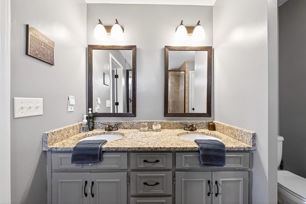 7333 Cedar Creek Loop Columbus, GA 31904 - Photo 20 of 37 a bathroom with a granite countertop sink and a mirror