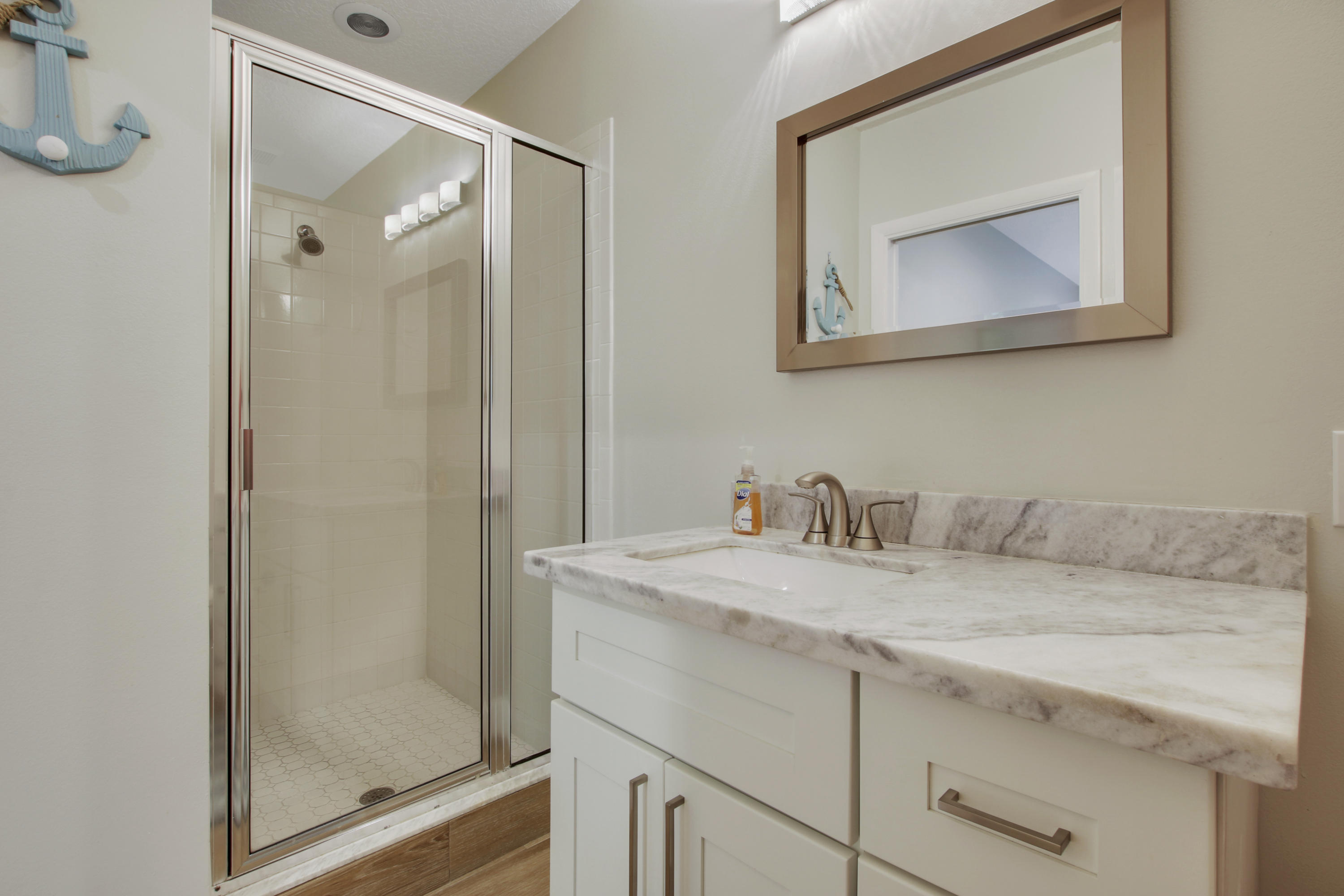380 North Juno Lane Juno Beach, FL 33408 - Photo 18 of 22 a bathroom with a granite countertop sink mirror and vanity