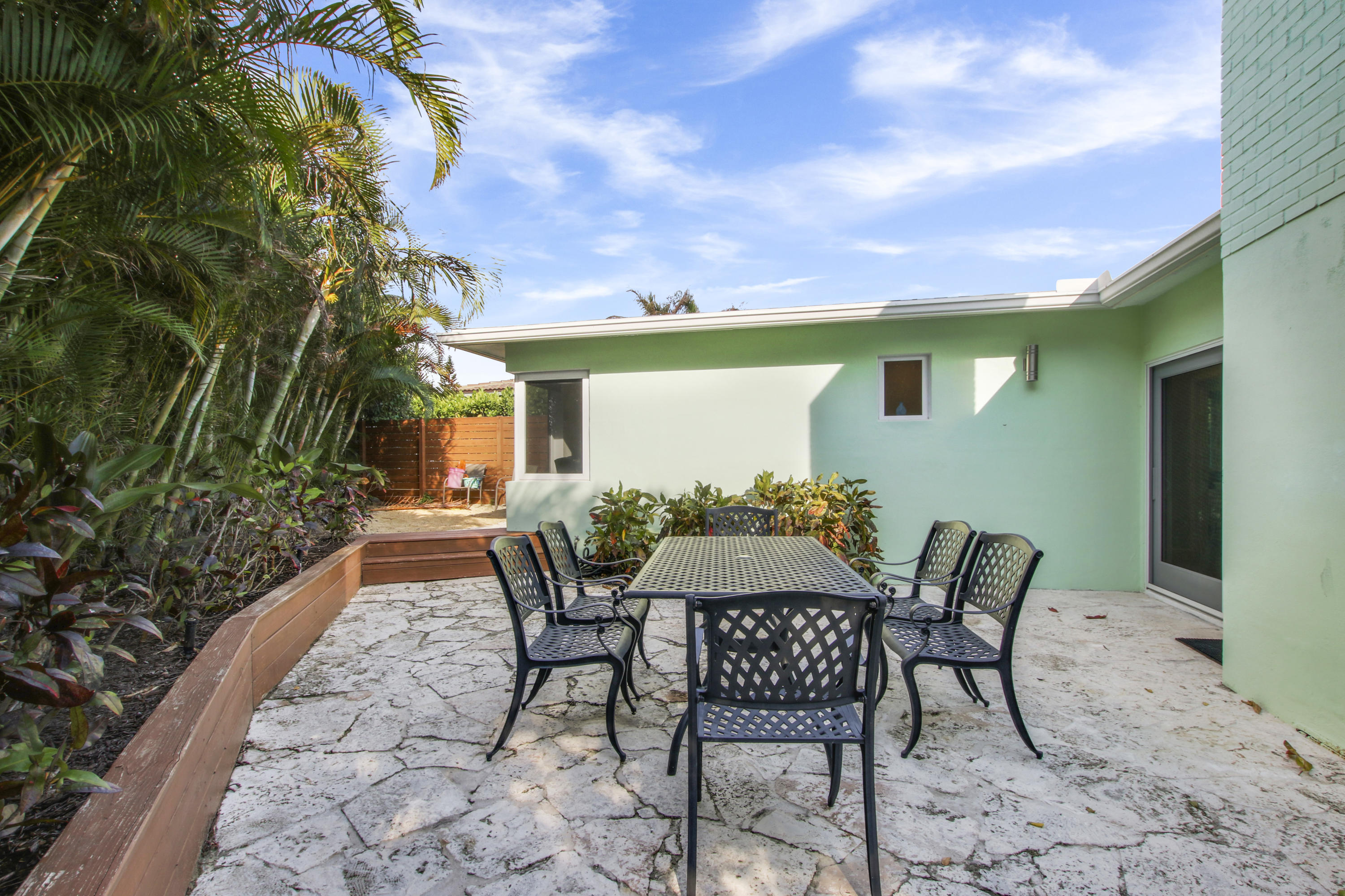 380 North Juno Lane Juno Beach, FL 33408 - Photo 20 of 22 a view of a patio with table and chairs and potted plants