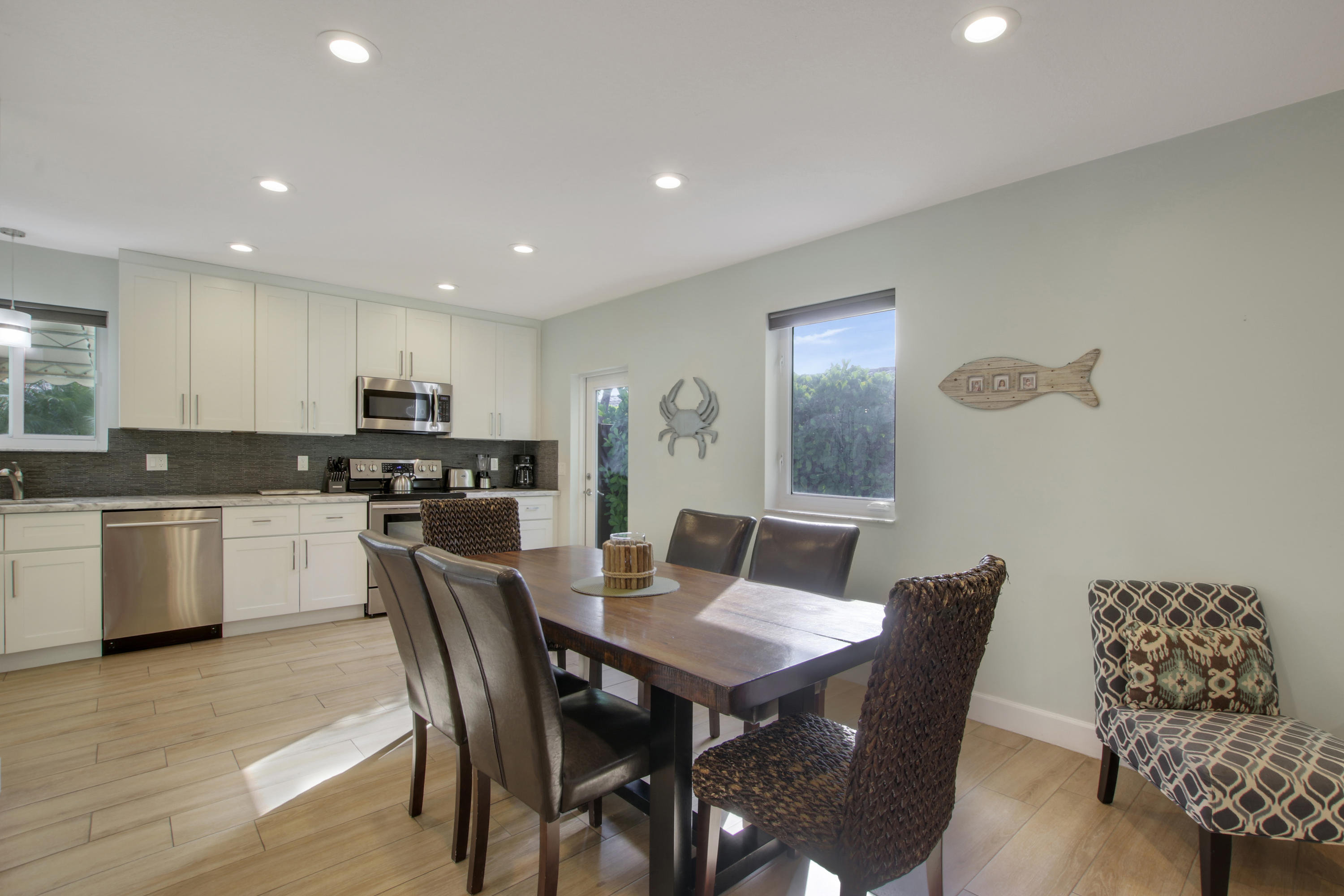 380 North Juno Lane Juno Beach, FL 33408 - Photo 6 of 22 a view of a dining room with furniture and wooden floor