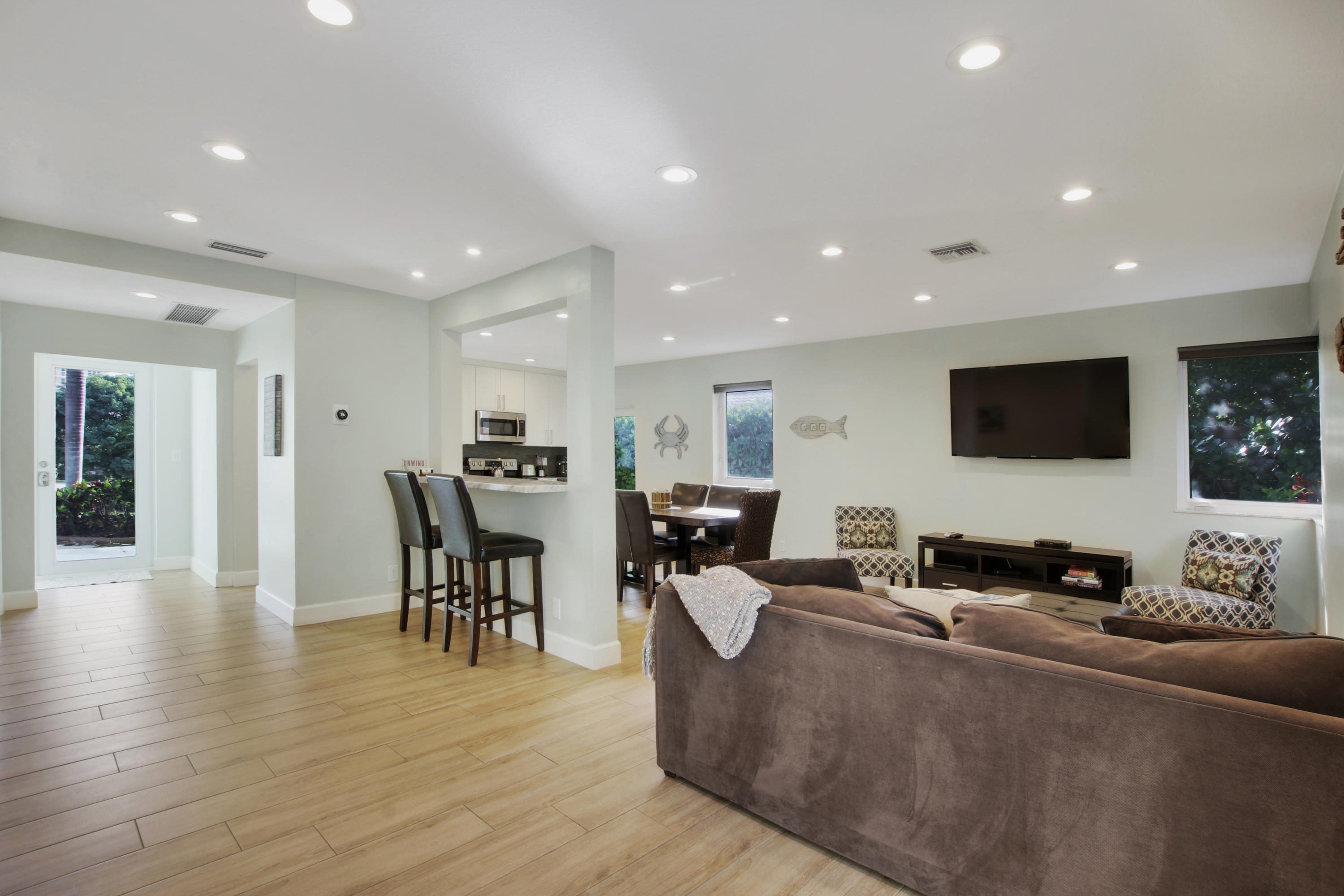 380 North Juno Lane Juno Beach, FL 33408 - Photo 7 of 22 a living room with furniture wooden floor and a flat screen tv