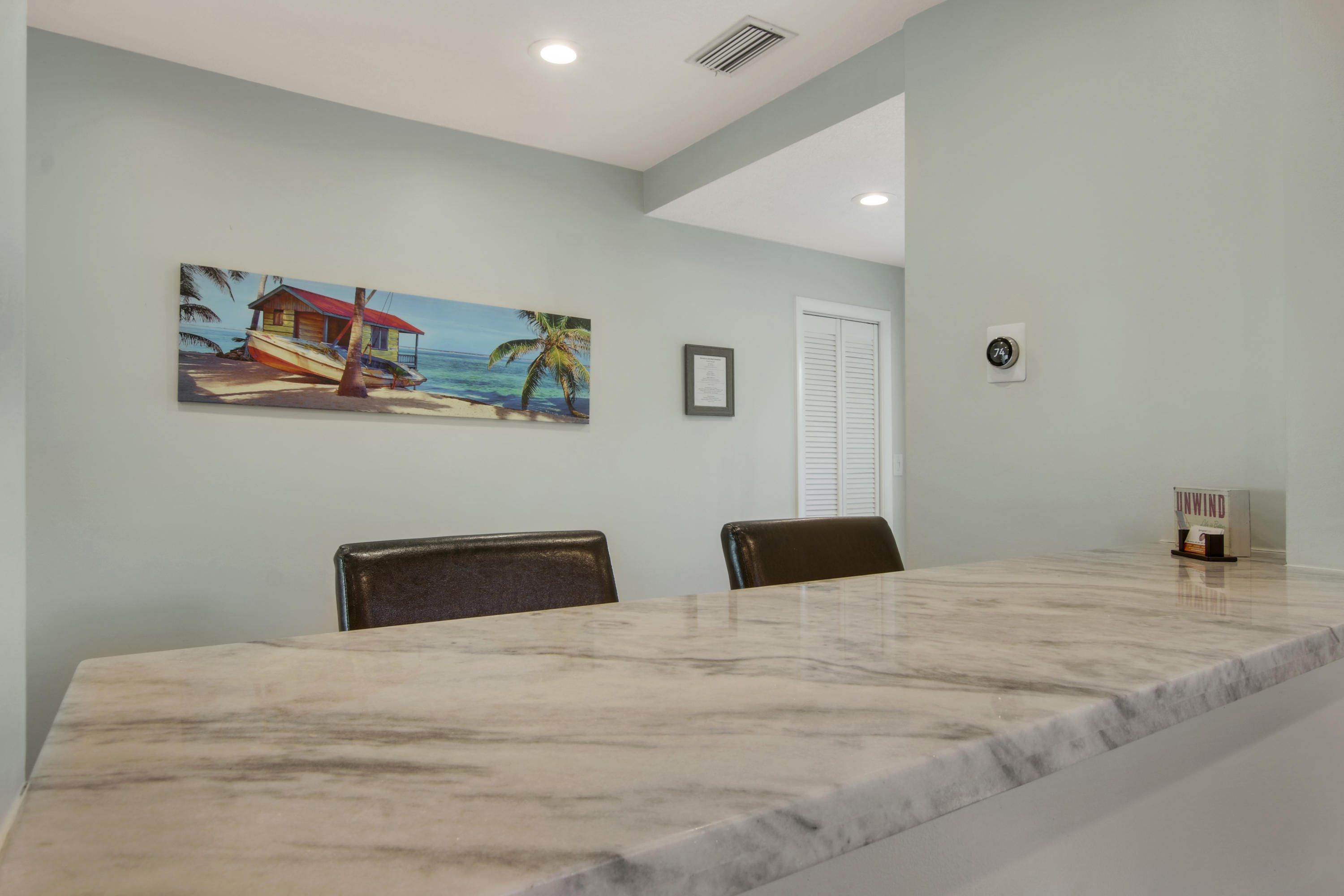 380 North Juno Lane Juno Beach, FL 33408 - Photo 10 of 22 a bedroom with a bed and painting on the wall