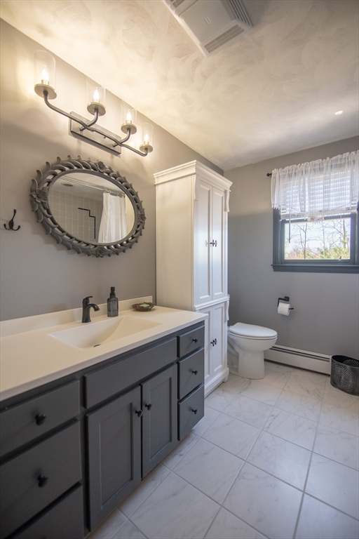 110 Mendon Road Northbridge, MA 01534 - Photo 24 of 37 a bathroom with a toilet a double vanity sink and a mirror