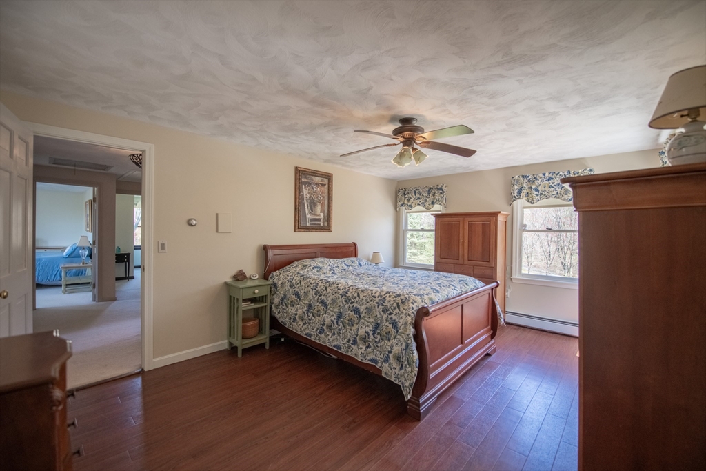 110 Mendon Road Northbridge, MA 01534 - Photo 27 of 37 a bedroom with a bed and a chandelier
